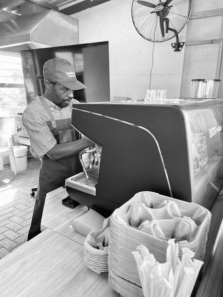 Barista working the espresso machine at Yellow's Bru