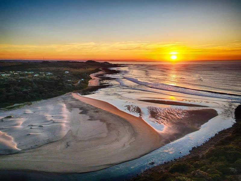 Sunset over the Kwelera River mouth and sandbanks at Yellow Sands